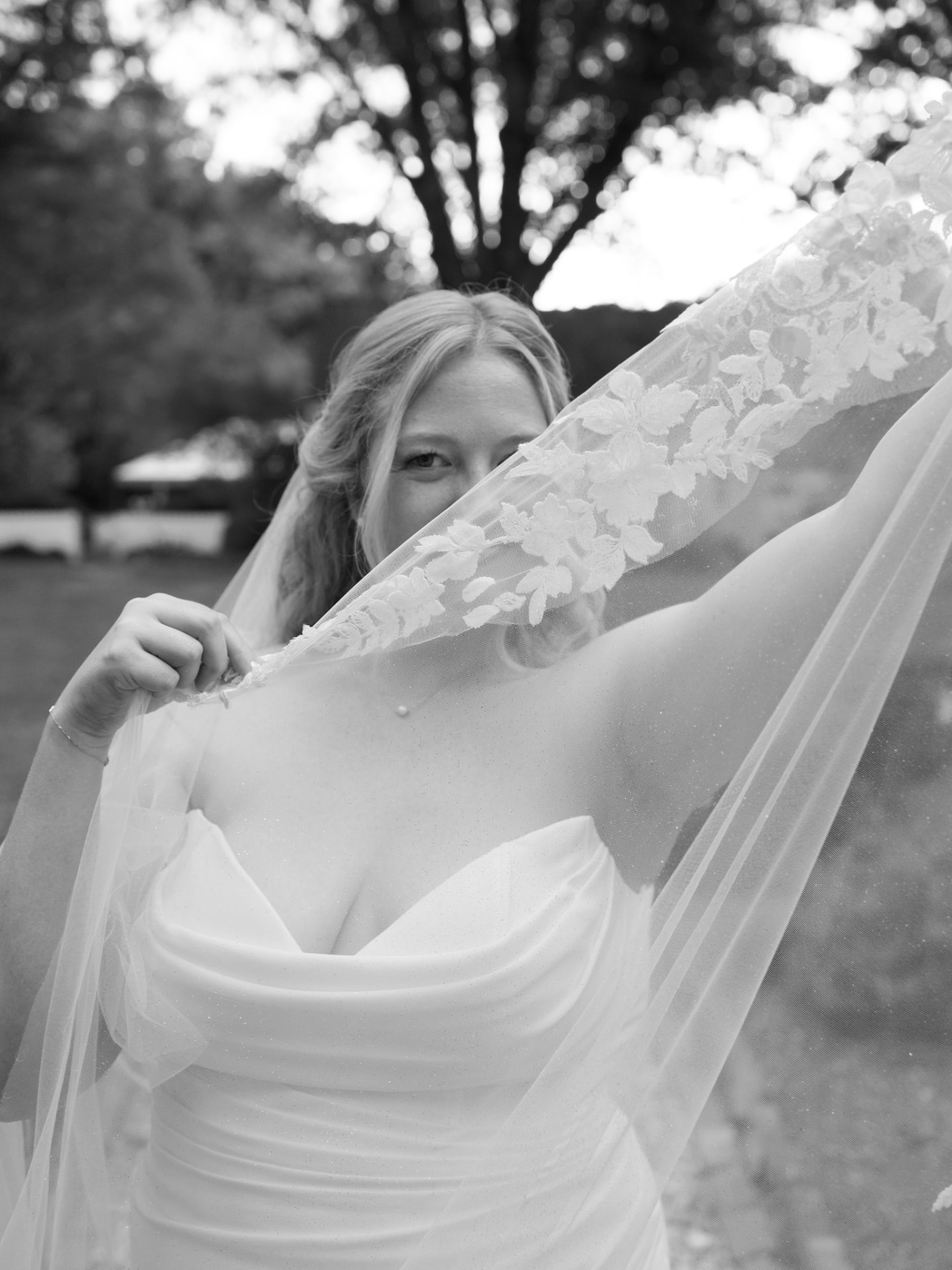 Bride holding her lace-trimmed custom veil